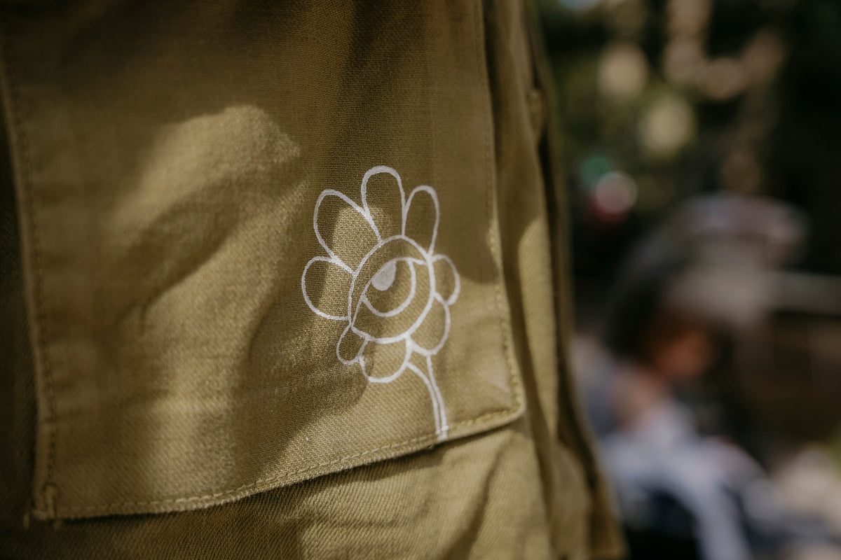 Detail auf Vintage Jeansjacke kleine Blume mit Auge